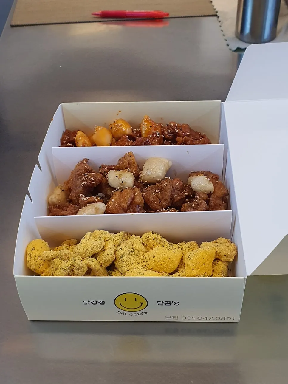 Takeout container with three flavors of dakgangjeong