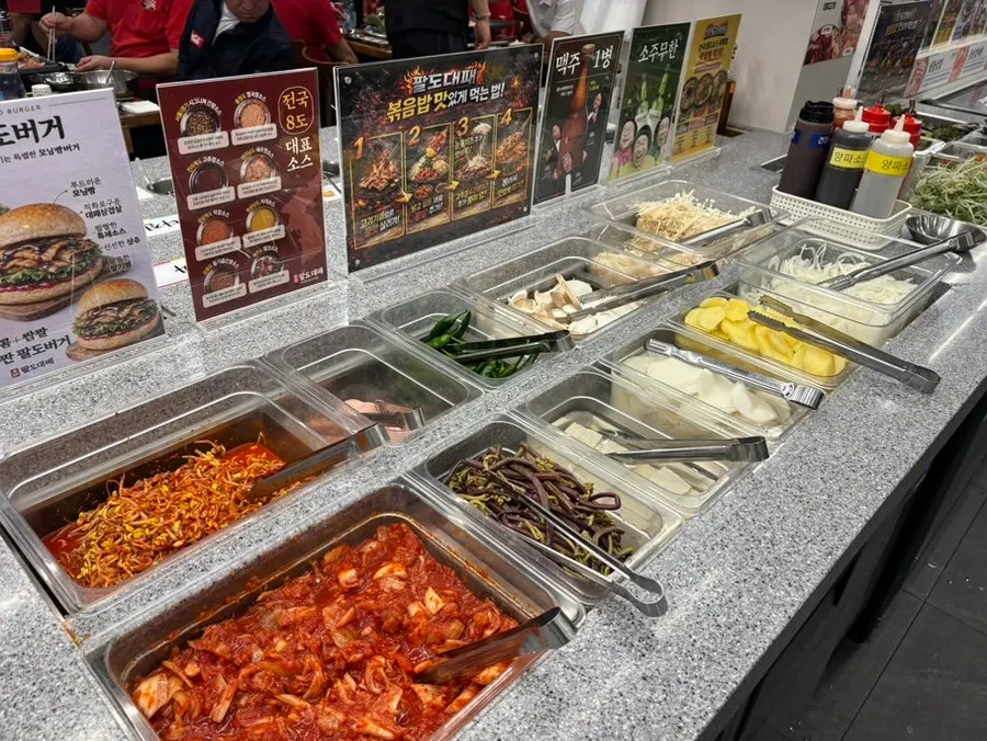 Grilling vegetable corner with kimchi, bean sprouts, and more