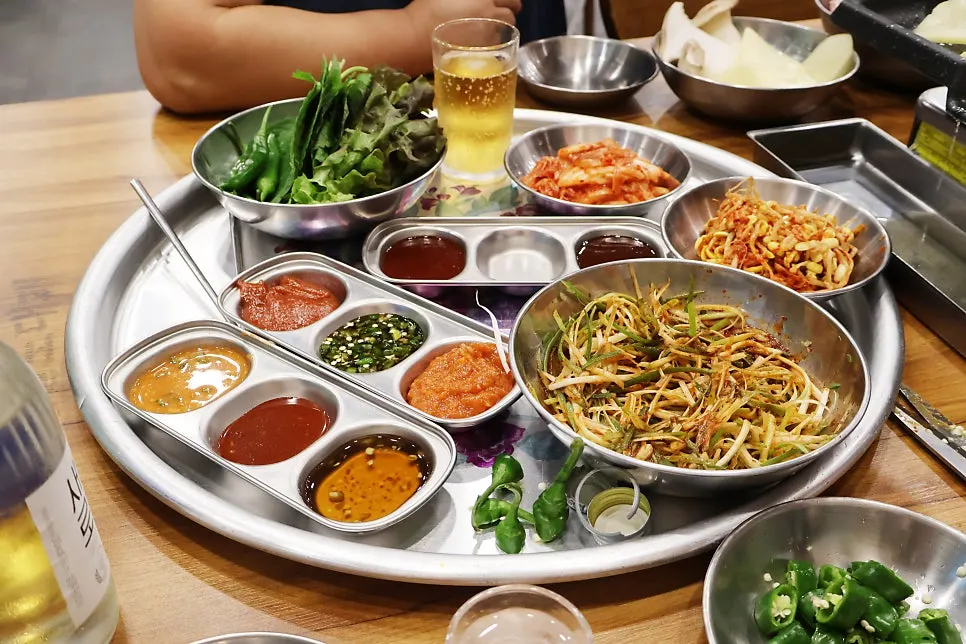 Plate of green onion strips and sauces brought to the table