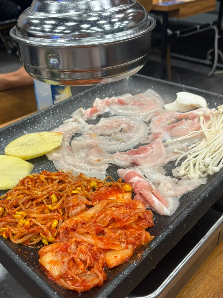 Thin-sliced pork belly cooking to a golden brown