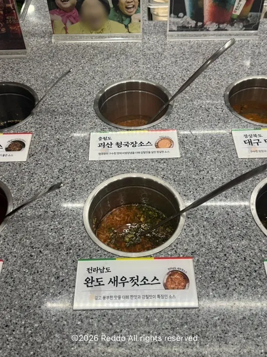 Self-serve bar with pink sausages for grilling
