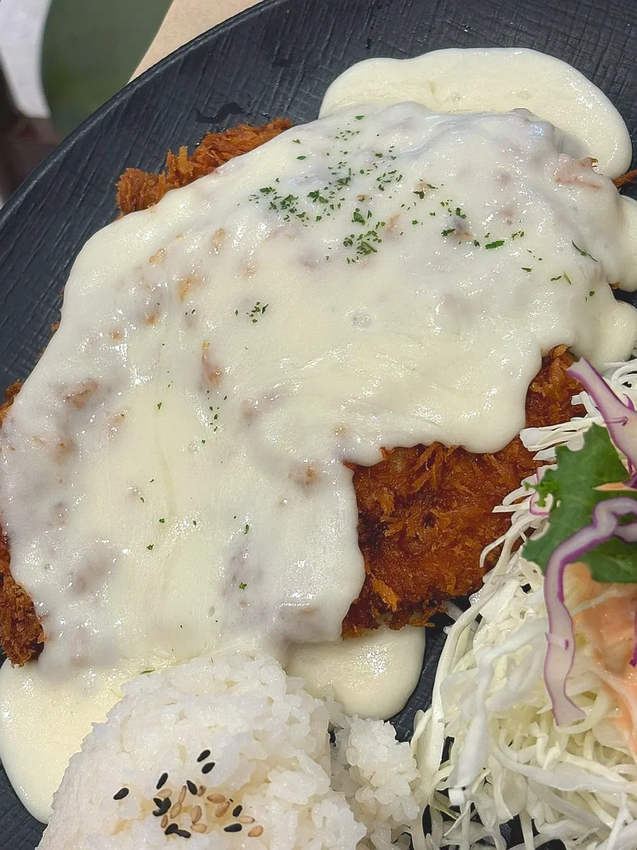 Cheese donkaseu with cheese covering the top of the cutlet