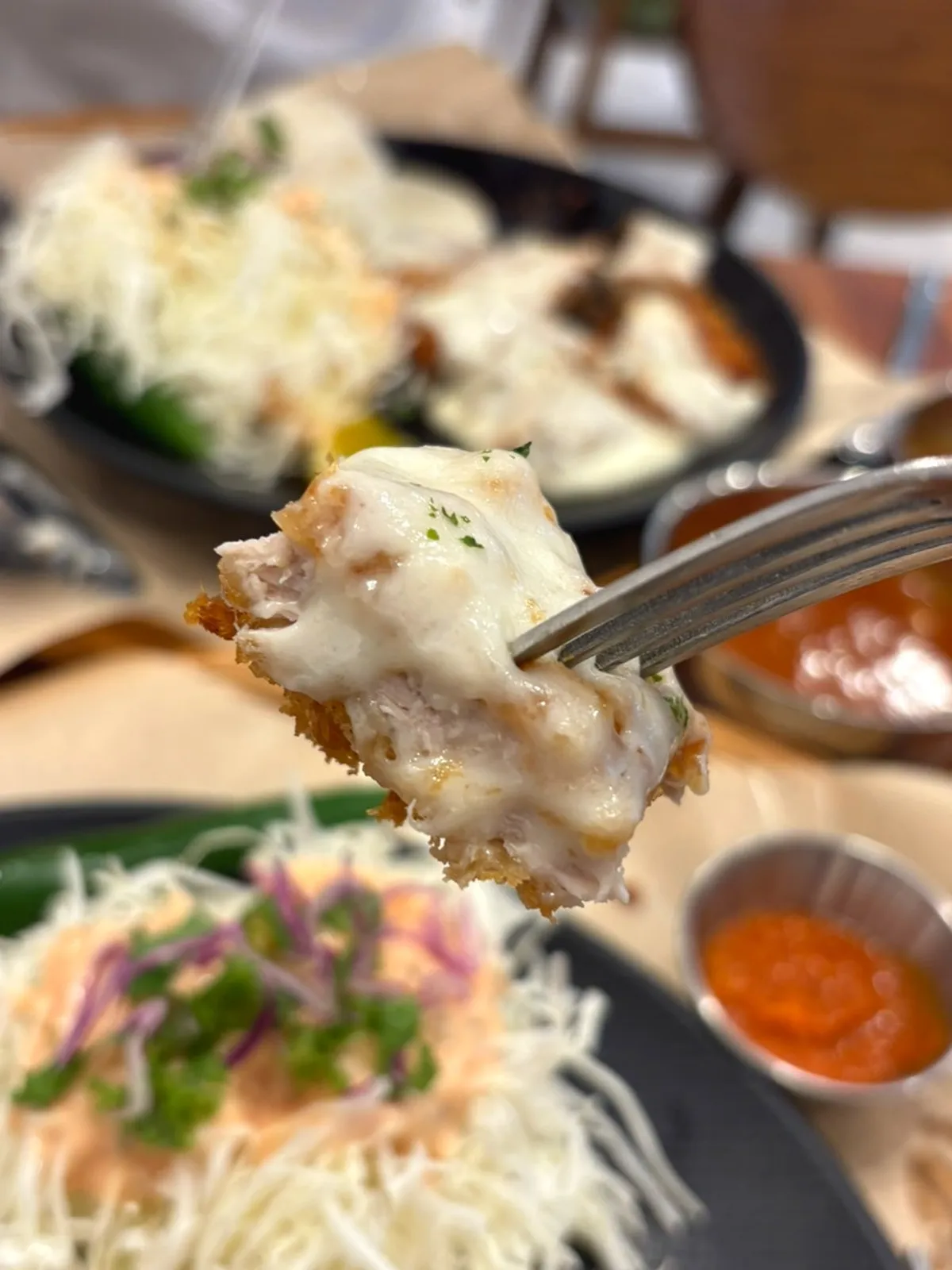 Dipping cheese donkaseu into sauce