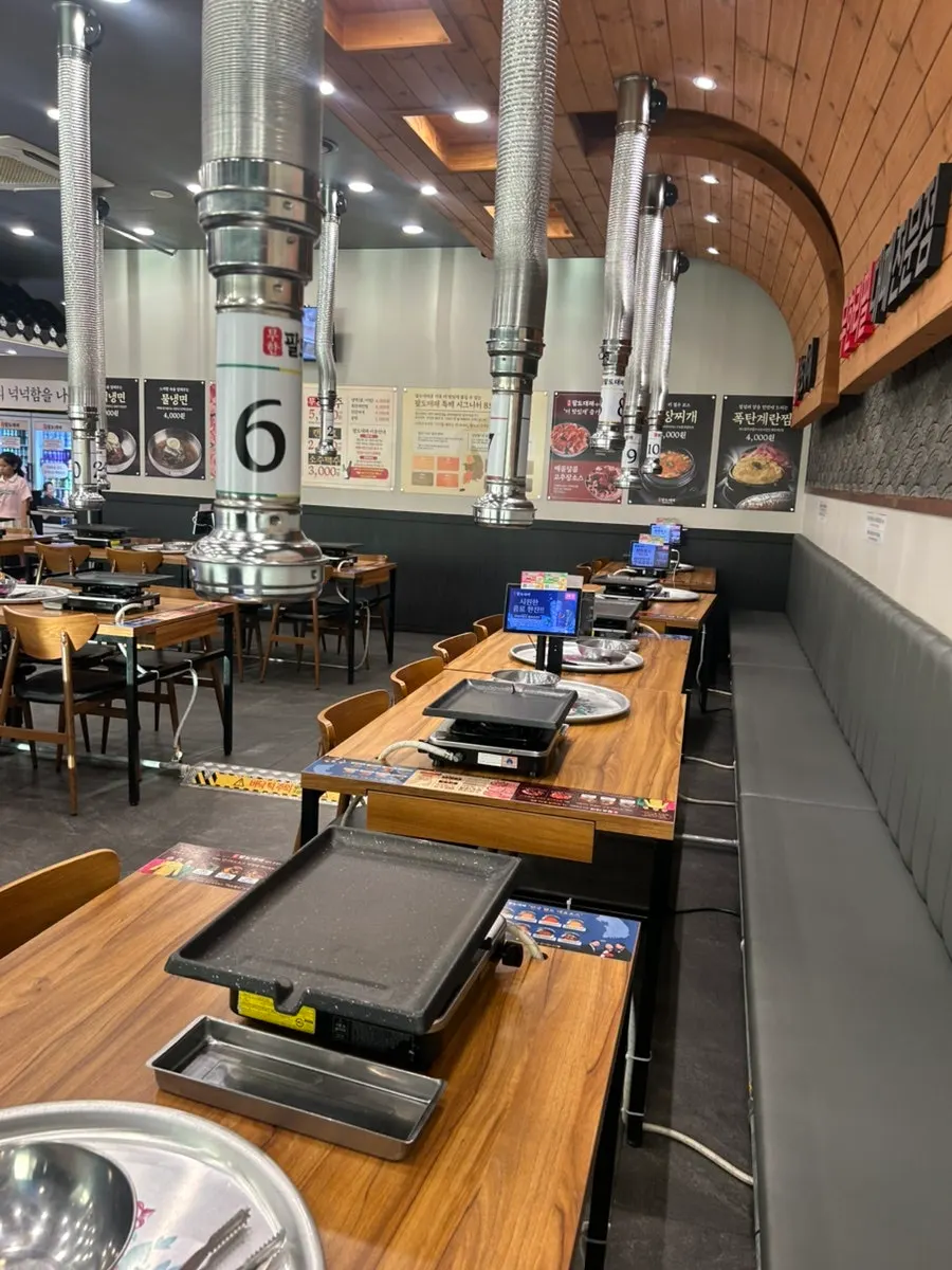 Restaurant interior with sign for all-you-can-drink soju