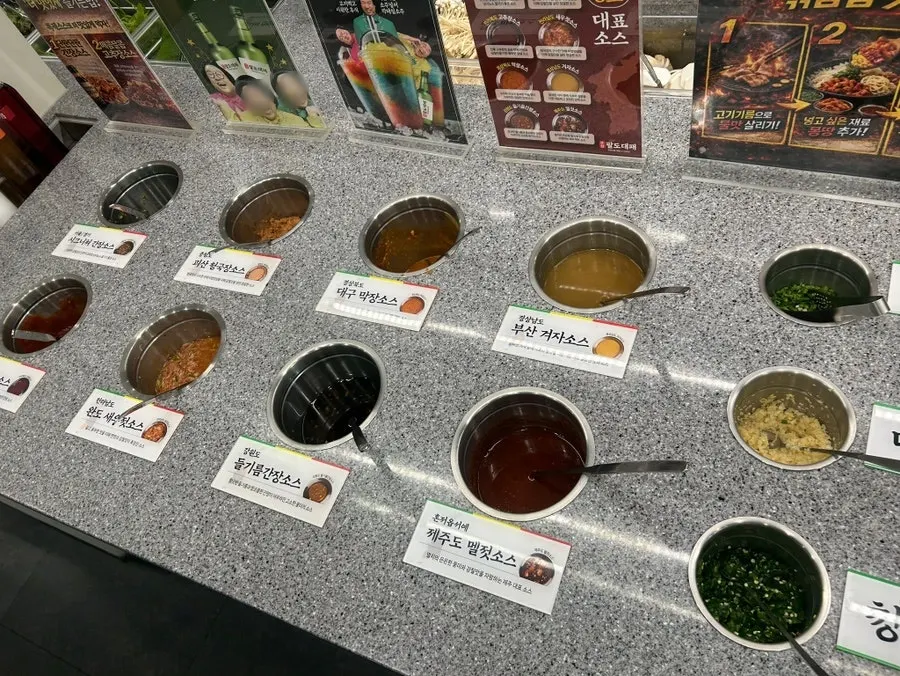 Self-serve side dish corner with kimchi, bean sprouts, and more