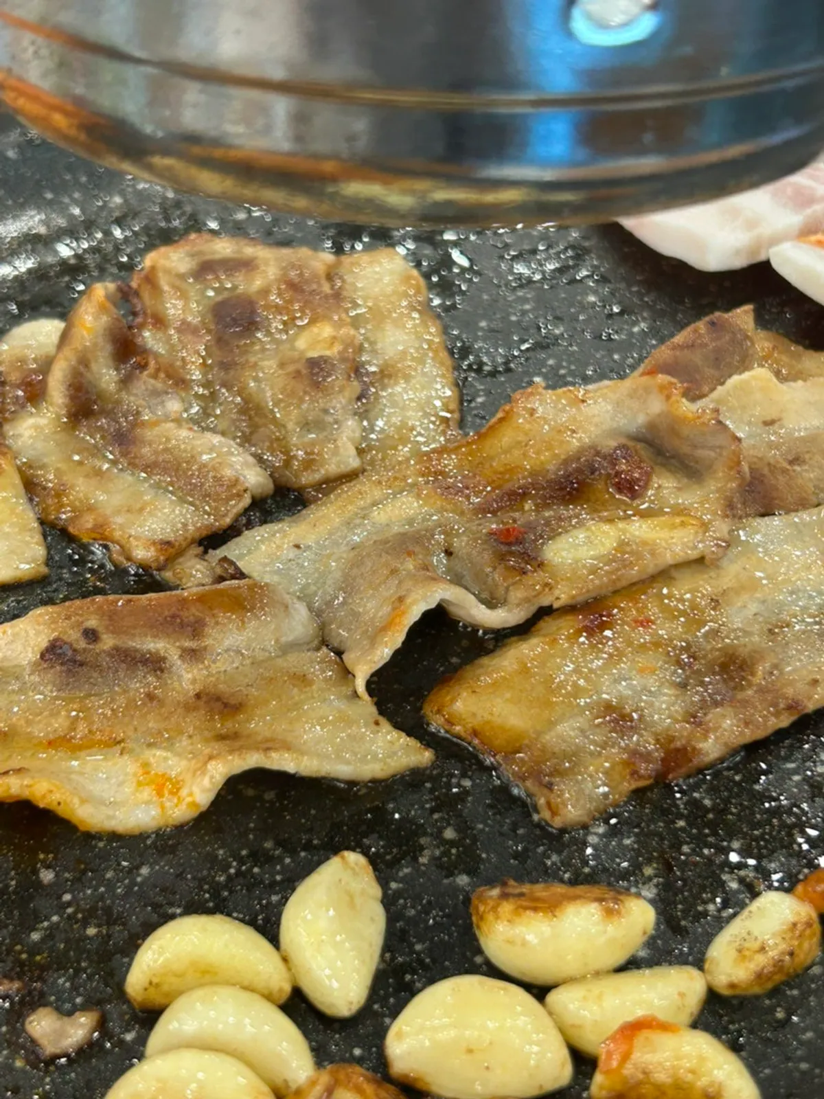 Daepae samgyeopsal cooking on the grill