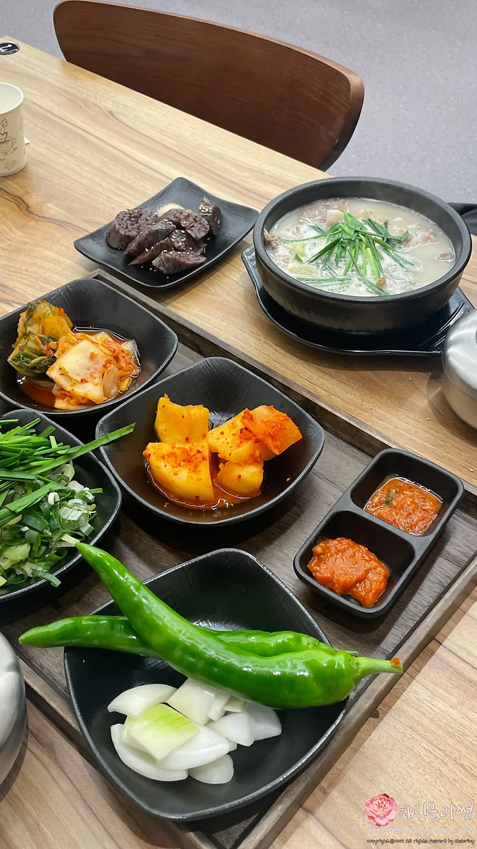 Meat lifted out of the pork gukbap with a spoon