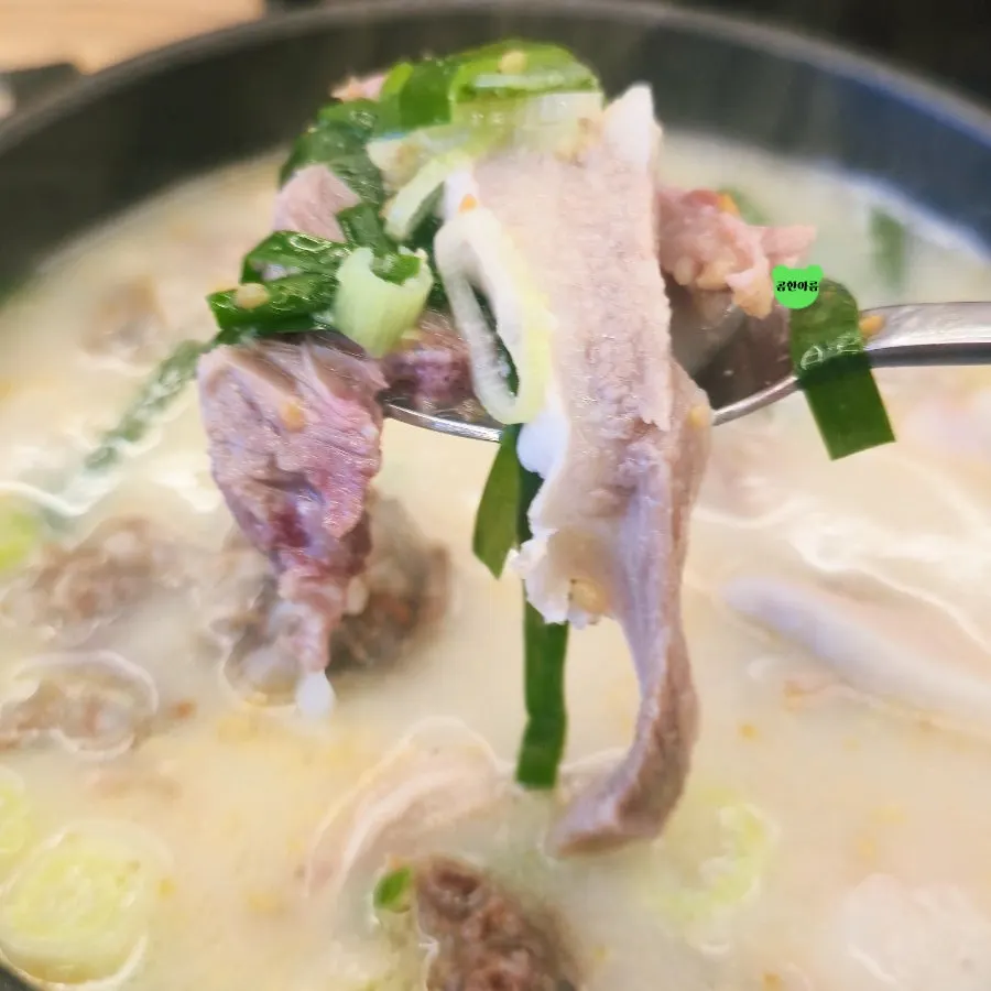 Meat lifted out of the gukbap with a spoon