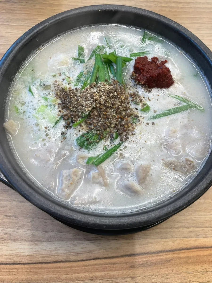 White sundaeguk broth topped generously with perilla seeds