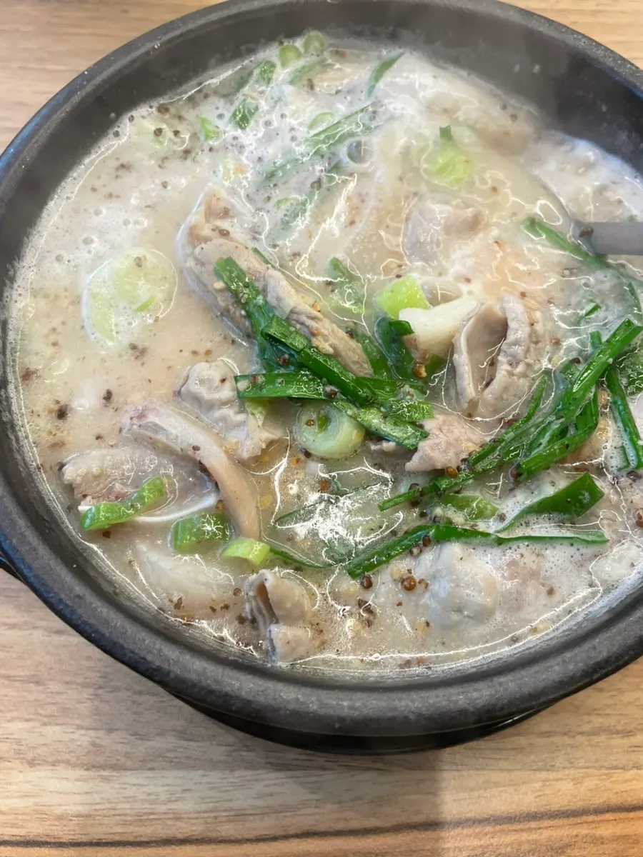 A spoonful of sundaeguk broth lifted up