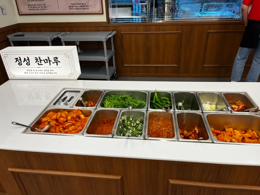 Spicy sundaeguk with rice mixed in and radish kimchi on top
