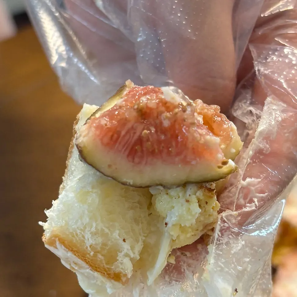 A bite of wakppu salt bread with cracked chocolate coating