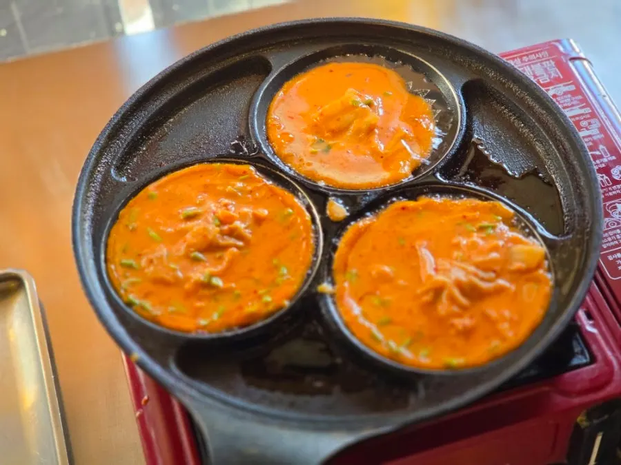 A plate of golden-grilled minari kimchi pancake