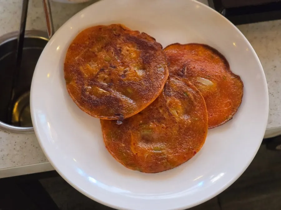 A piece of kimchi pancake full of minari fragrance