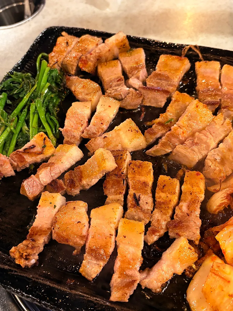 Pork belly turning golden brown while grilling