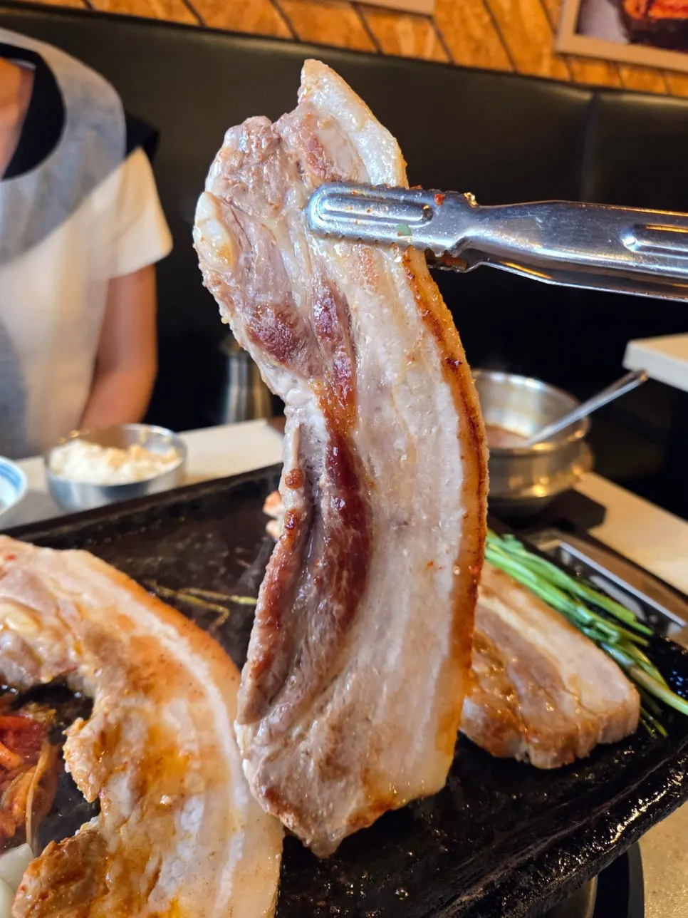 A whole chunk of pork belly grilling