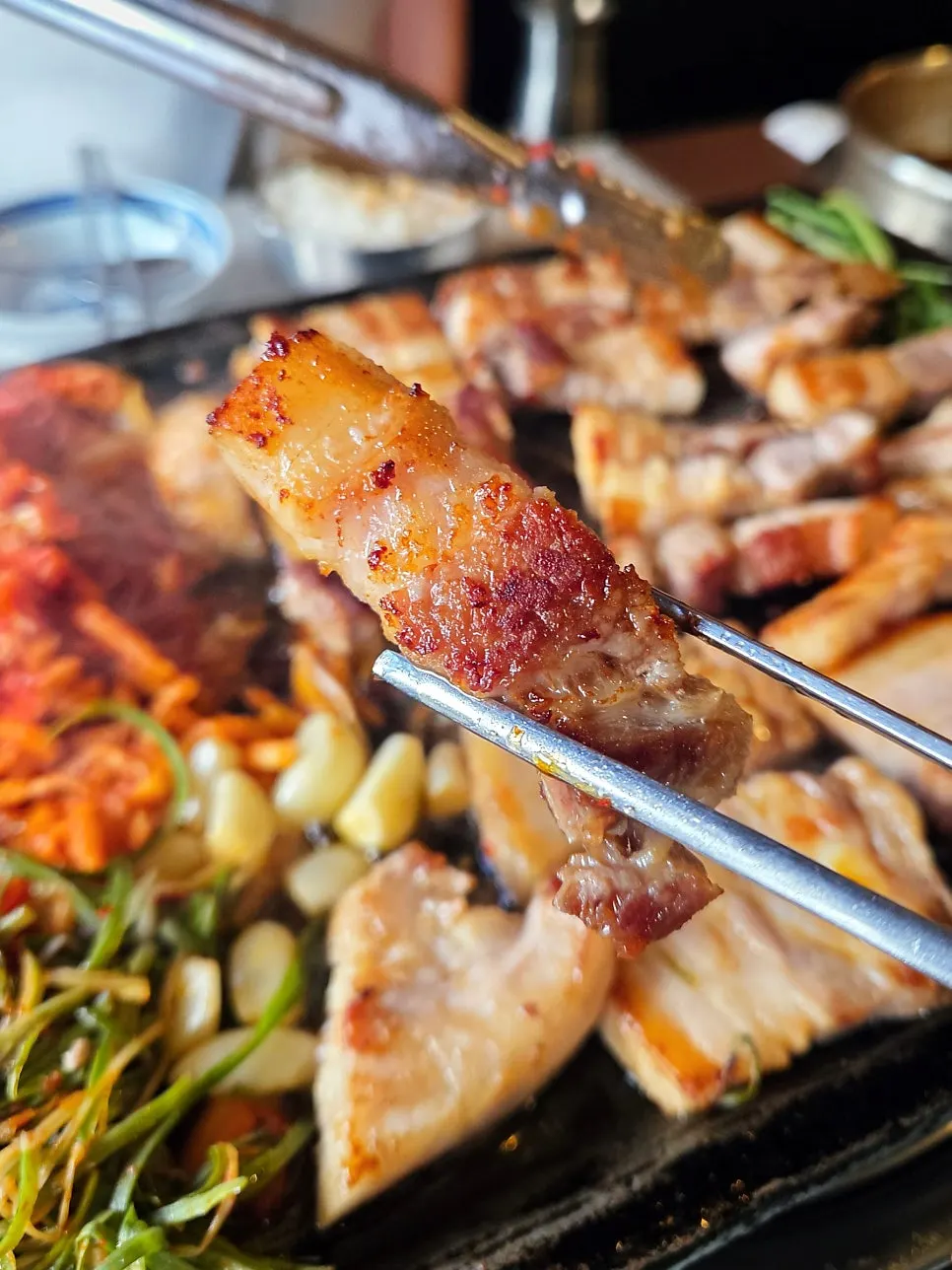 A piece of pork belly placed on a lettuce wrap