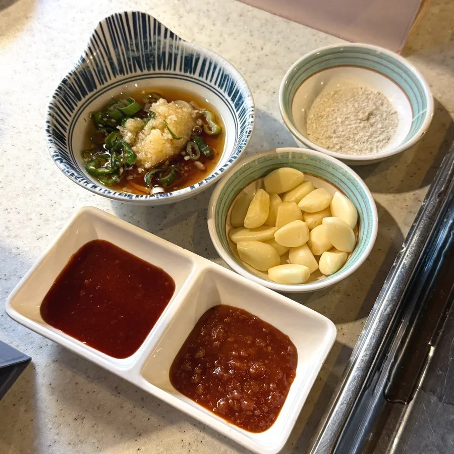 A basket of wrap vegetables with minari, perilla leaves, and lettuce