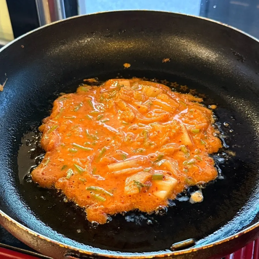 Self-cooked minari kimchi pancake on the grill