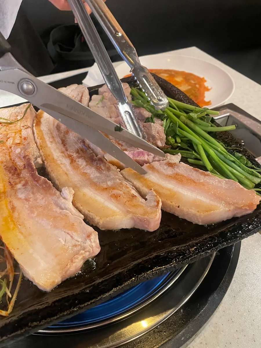 Thick-cut pork belly grilling on the pan