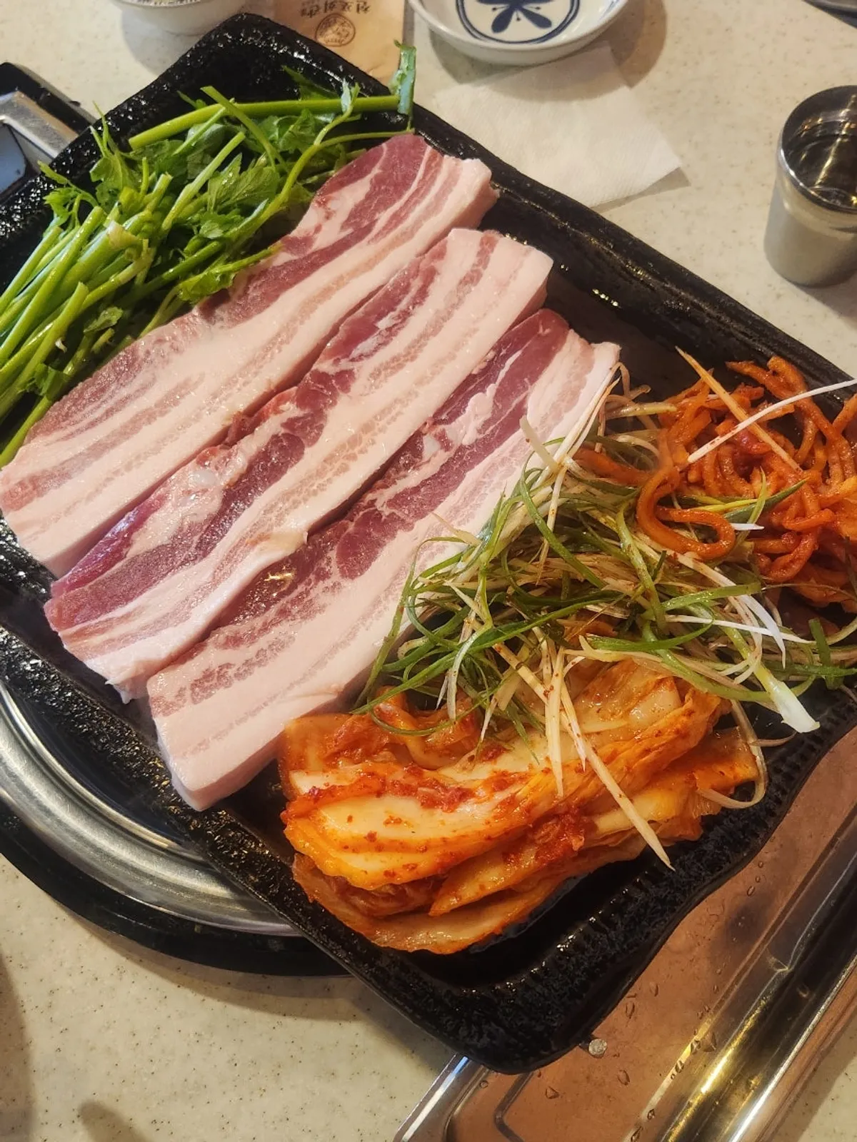 Full spread of side dishes before pork belly