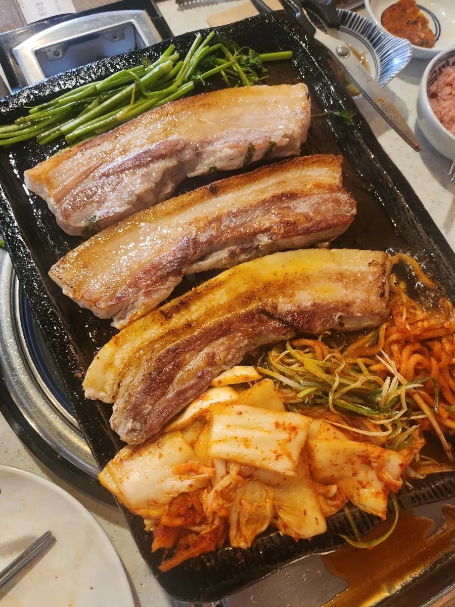 Pork belly grilling on the hot plate