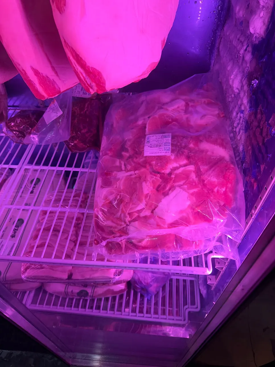 Meat fridge visible near the entrance