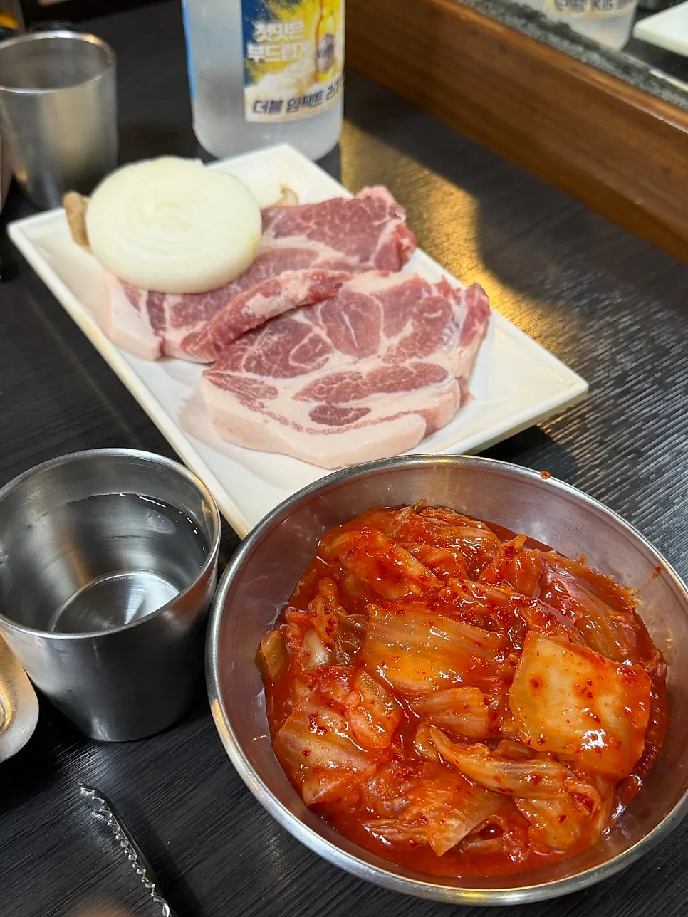 Two servings of pork neck placed on the cauldron lid