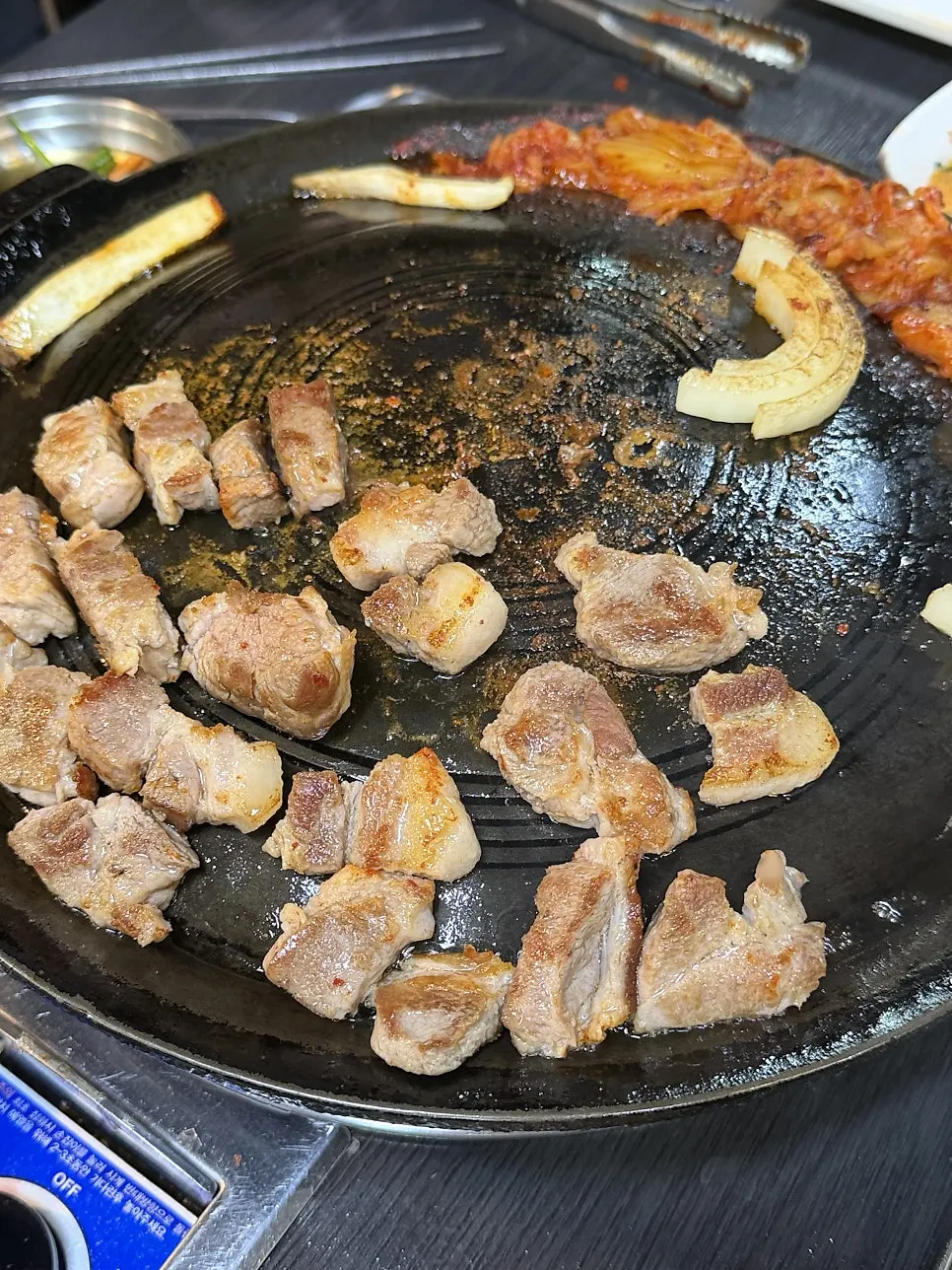 Grilled kimchi turned golden in the meat's fat, alongside the meat