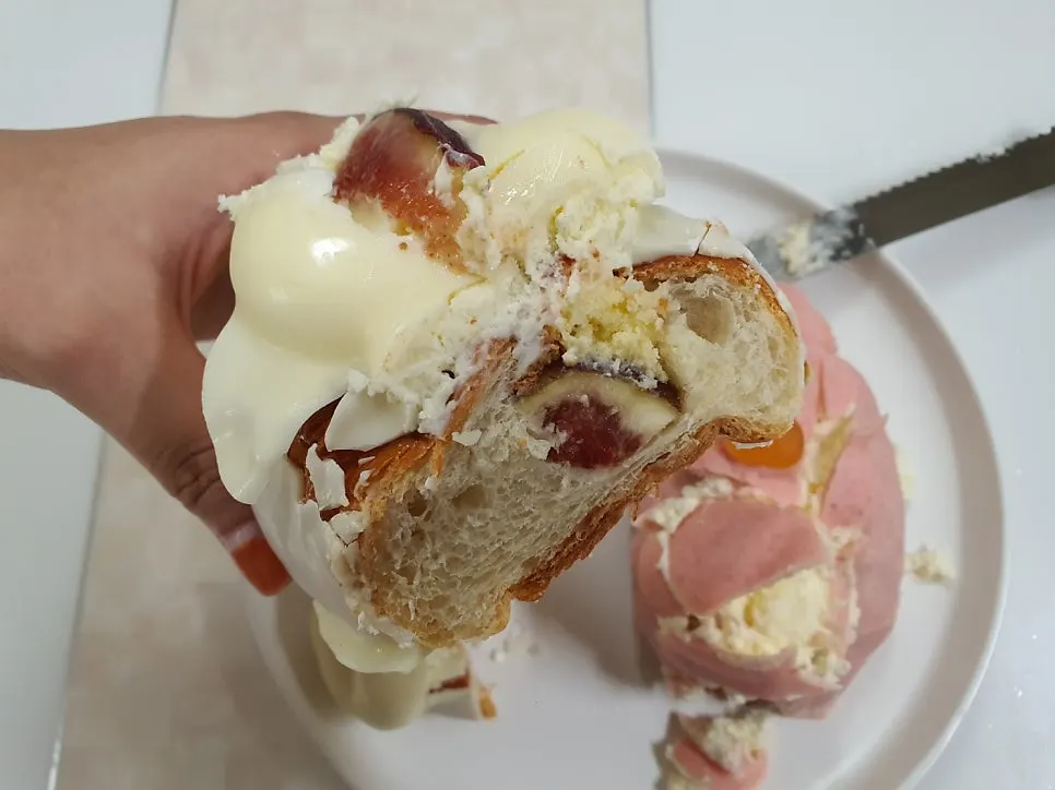 Cross-section of wakppu salt bread with a whole peach inside