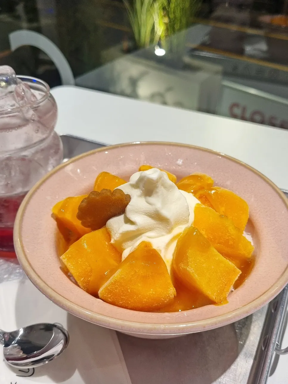 Snow-flake iced persimmon bingsu and homemade omija ade on the table