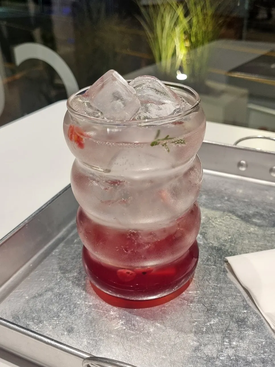 A glass of orange-hued homemade omija ade