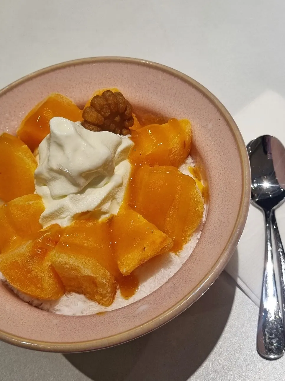 Iced persimmon bingsu topped with milk ice cream and mini yakgwa