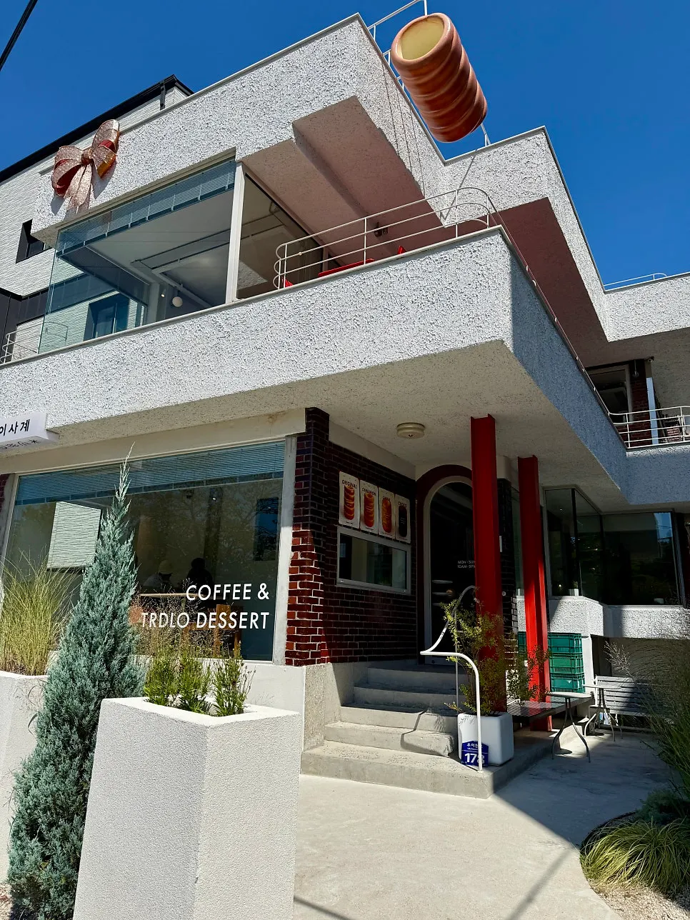 Café exterior wall with ribbons and a chimney bread model