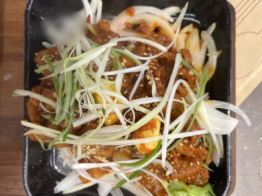 A plate of wood-fired pork over onions
