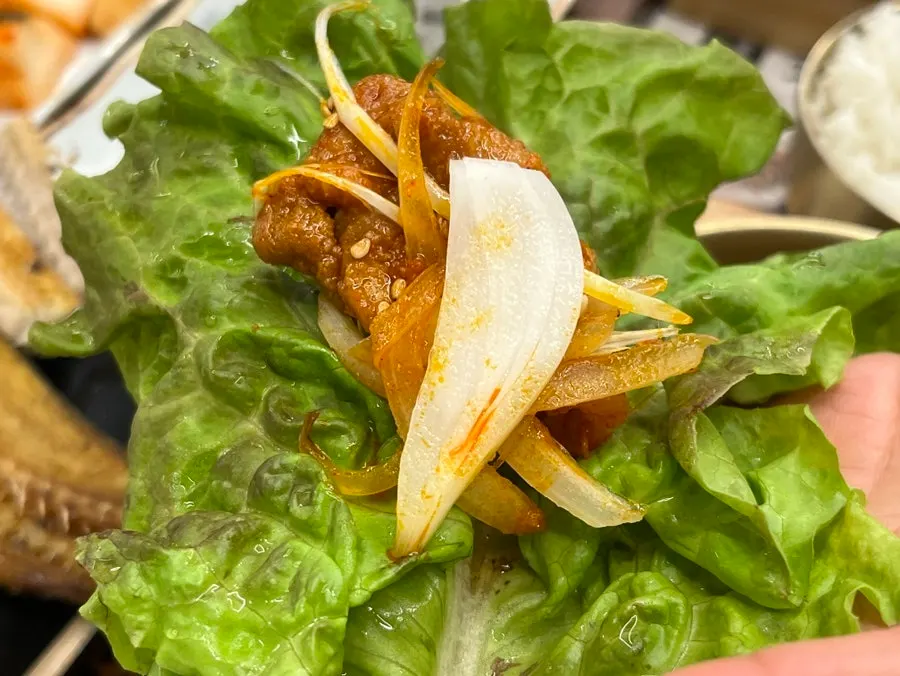 A lettuce wrap with pork and rice