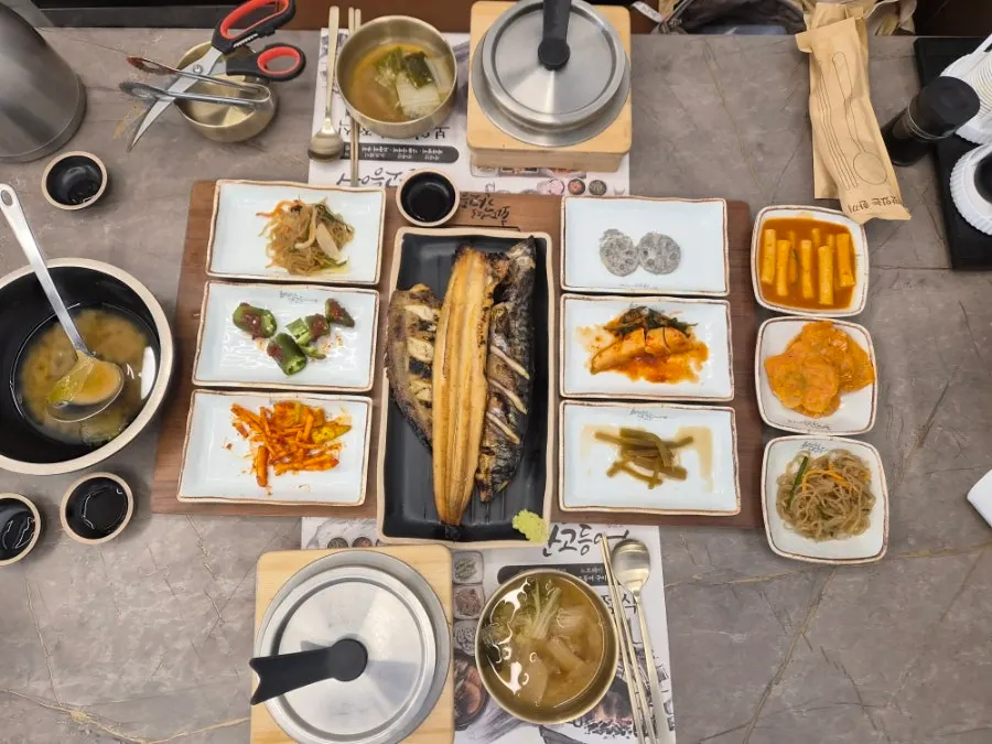 Full table with the two-person set and braised fish