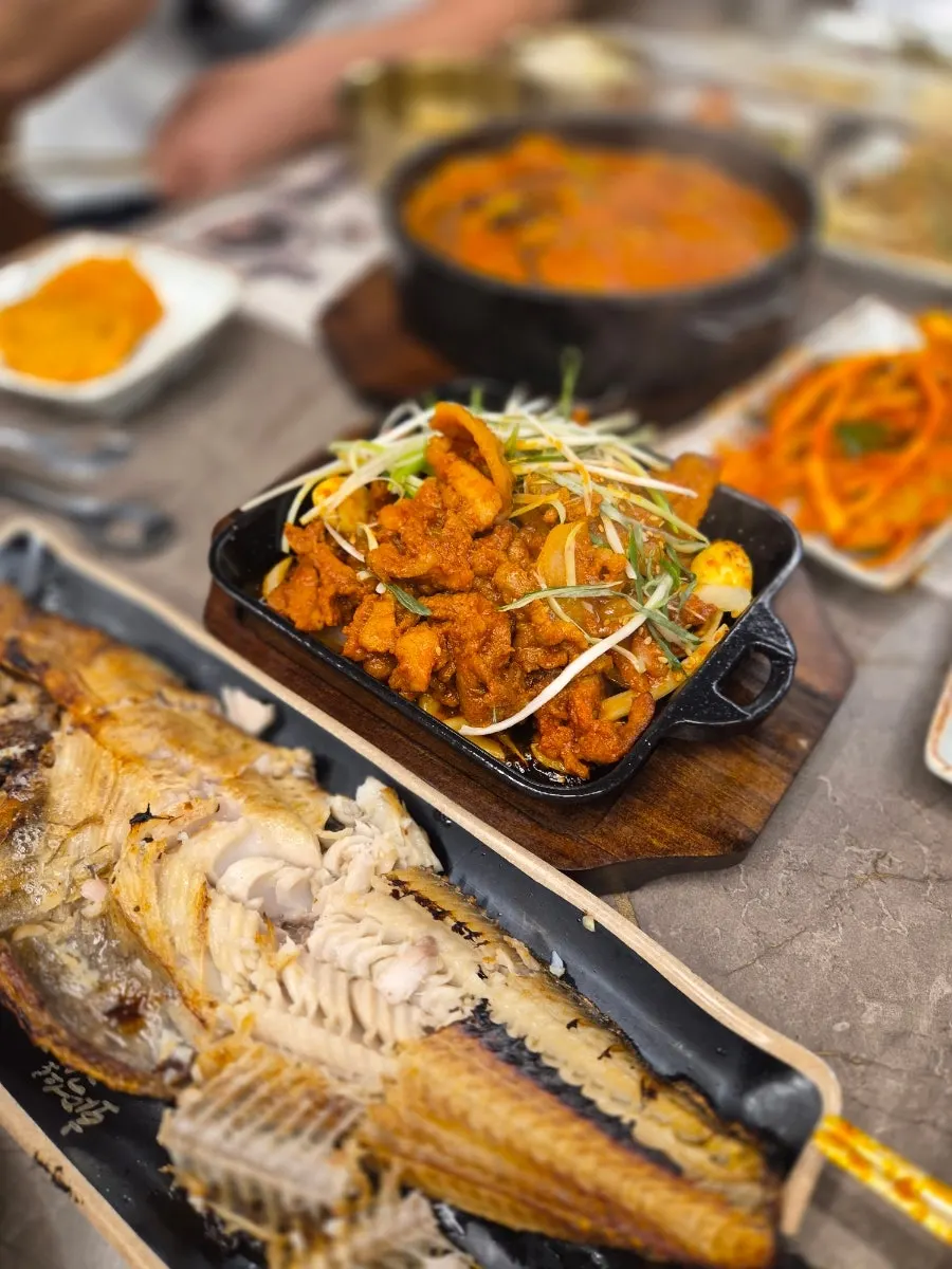 A table spread with more than 10 side dishes