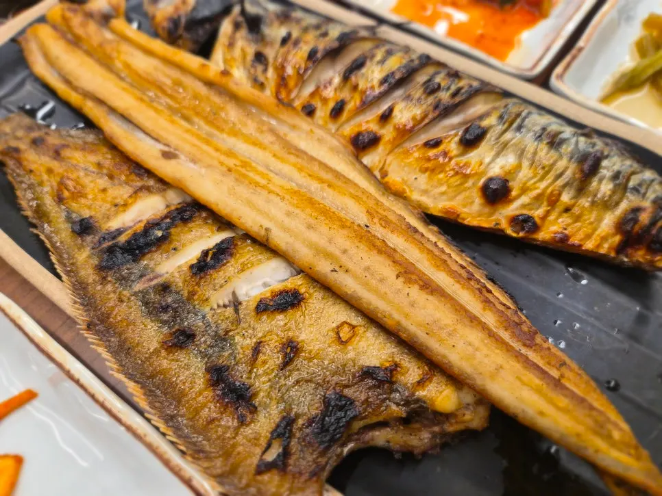 Plate of wood-fired grilled mackerel and oily flounder