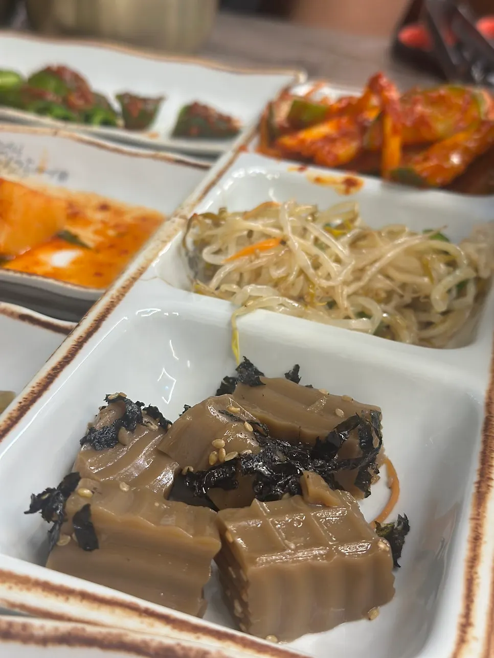 Plate of japchae and savory pancakes among the side dishes