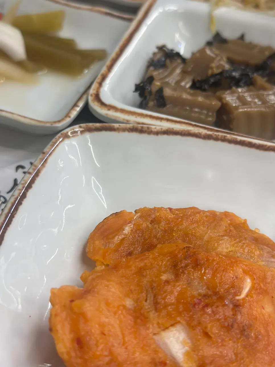 Plate of tteokbokki and seasoned vegetable side dishes