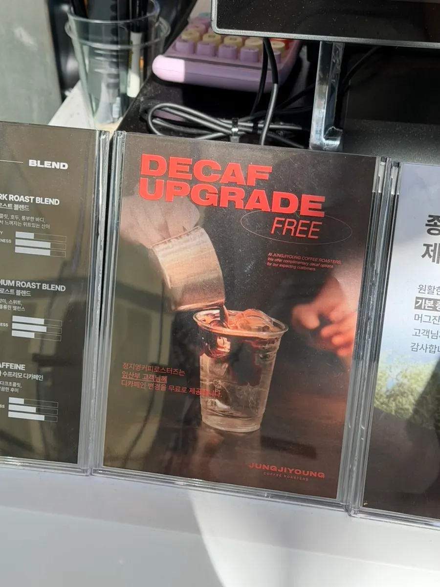 Order counter with a sign showing three types of coffee beans