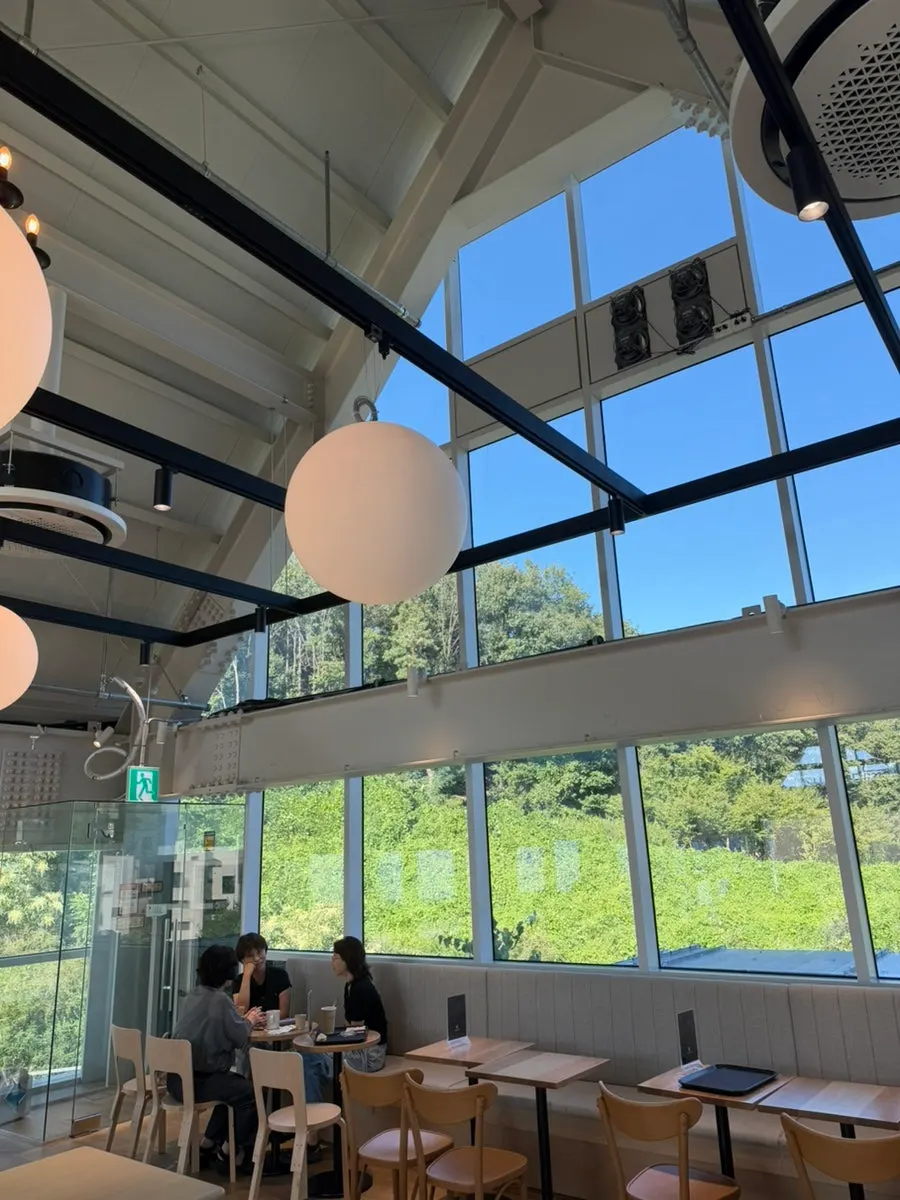 Lush green scenery visible through the floor-to-ceiling windows
