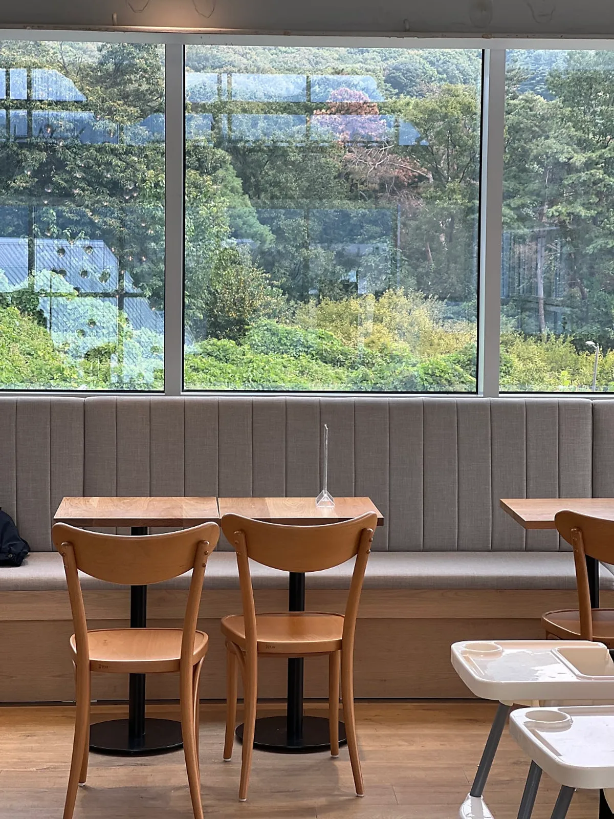Green outdoor scenery visible from the 2nd-floor window
