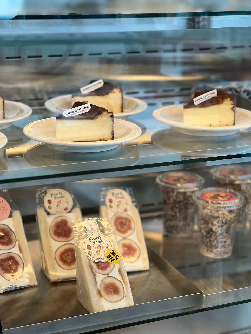 Display of Basque cheesecake and fruit sando desserts