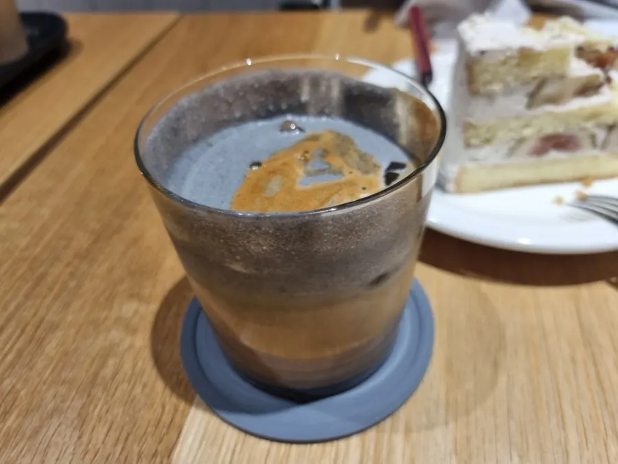 Iced black sesame latte topped with black sesame cream