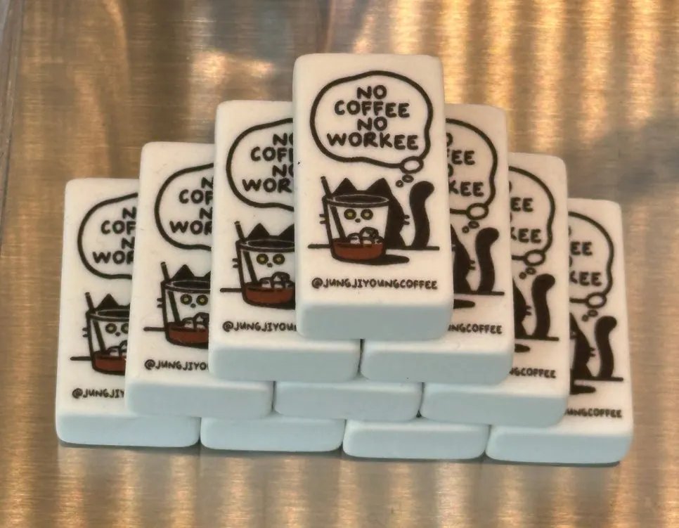 Eraser merchandise reading “NO COFFE NO WORK”