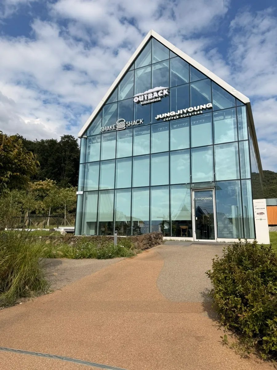 Glass building exterior showing the Jeong Jiyoung Coffee Roasters sign