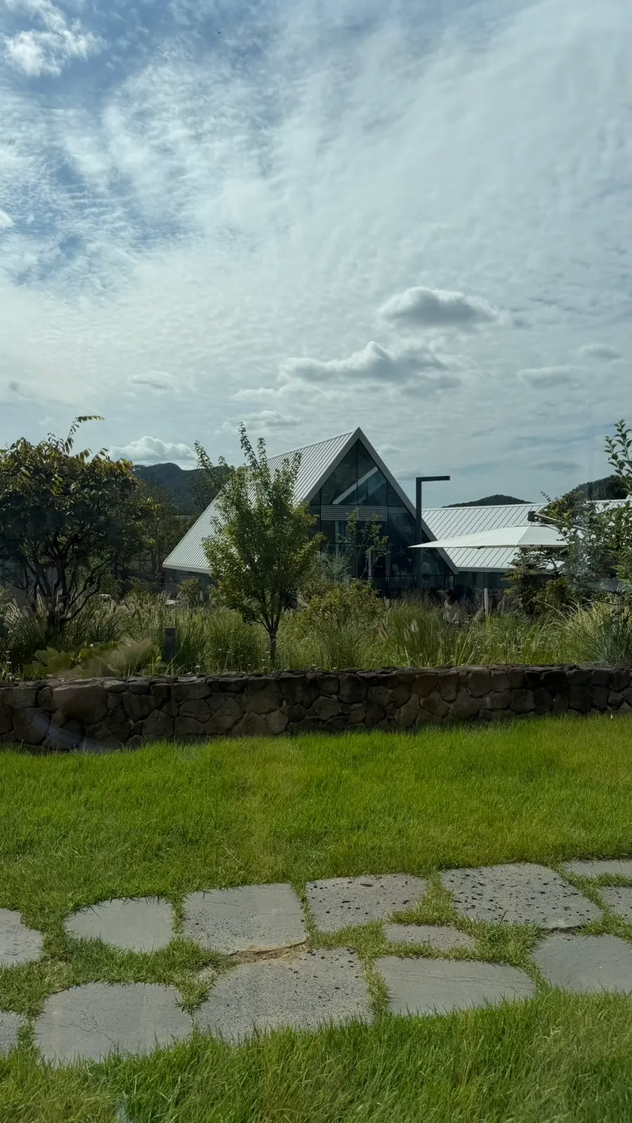 Green lawn and stone path in front of the café