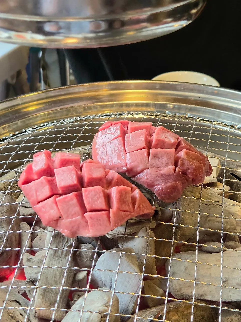 Beef tongue grilling over charcoal